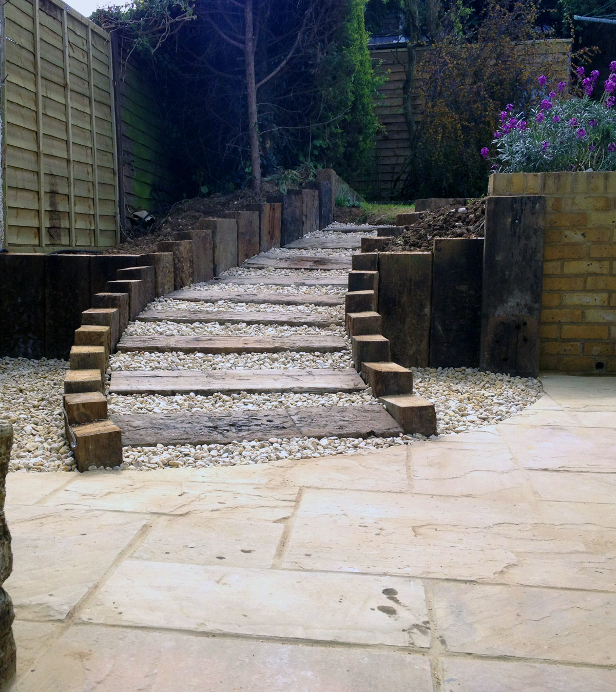 curved steps leading from garden to stone patio